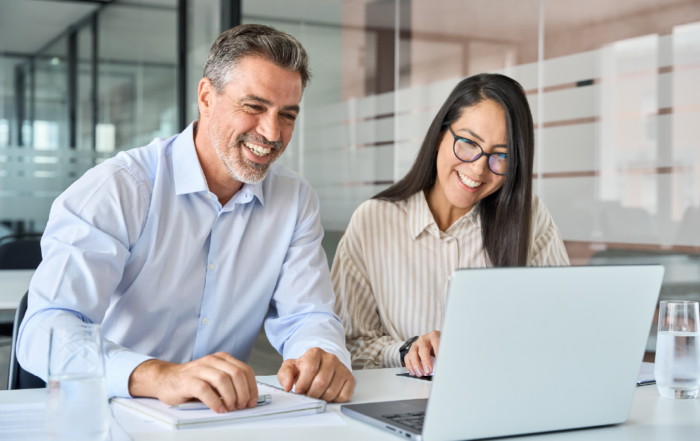 A salesman and saleswomen in a dealership using CitNOW Insights