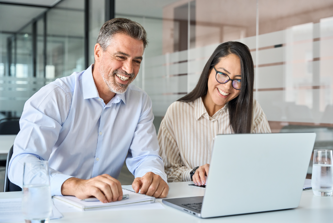 A salesman and saleswomen in a dealership using CitNOW Insights